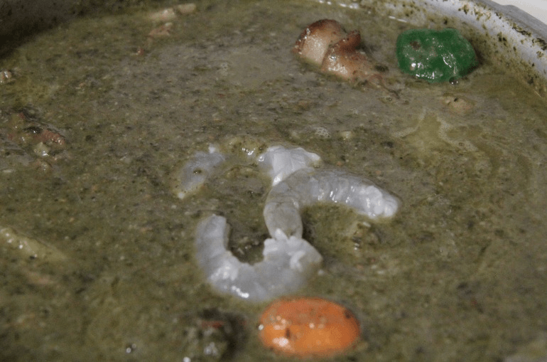 Pepperpot soup with shrimp on top